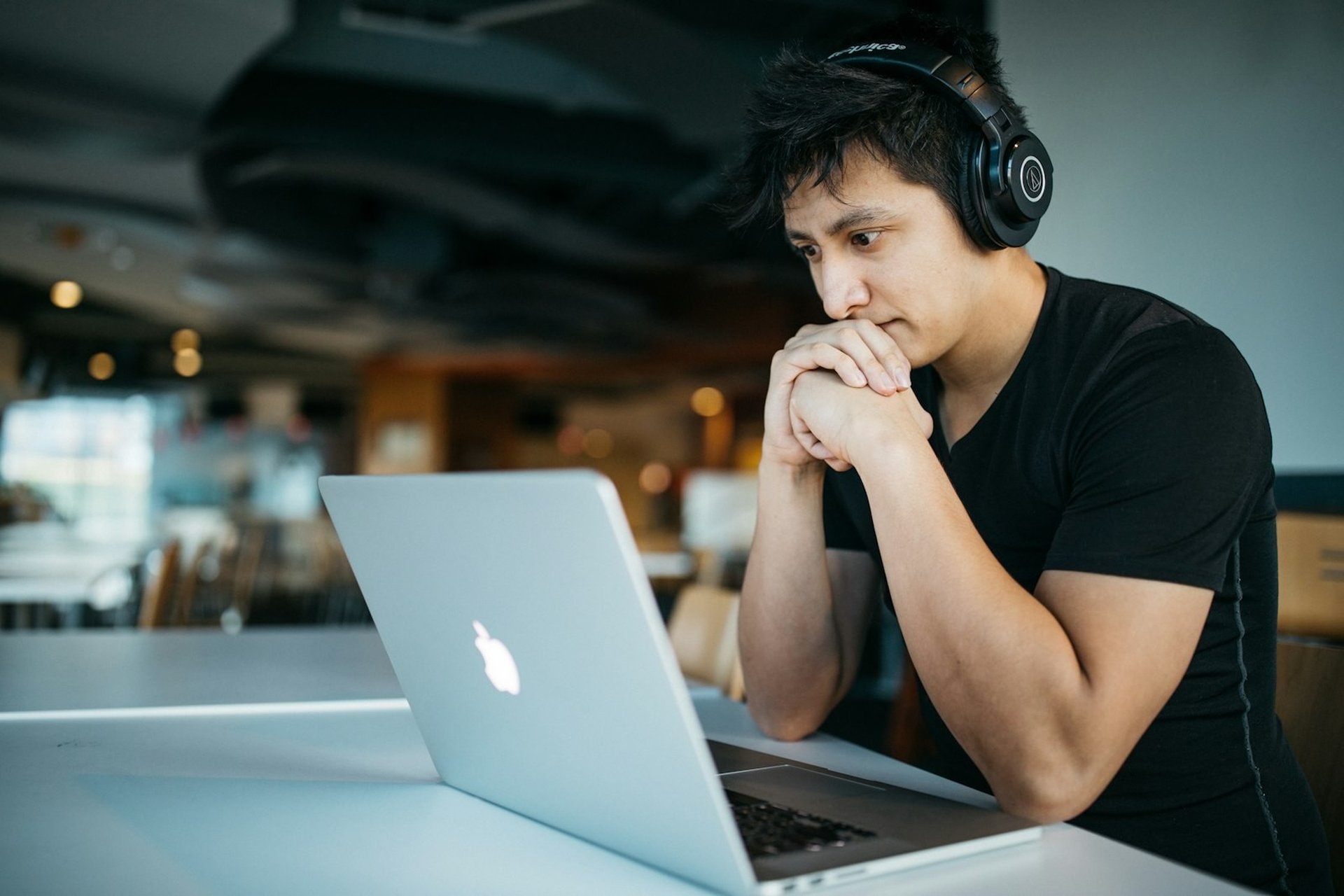 Student focused on their laptop studying the Bachelor of Science in Actuarial Science online